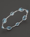 Blue topaz stations sparkle on this textured sterling silver bangle from Ippolita.