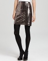 Come slither into the season's top trend in this python-print T Tahari sequin skirt, styled in a sleek pencil silhouette for a sparkling second-skin fit.