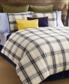 Tommy Hilfiger's Lake George comforter set features a classic plaid design in olive, blue and ivory tones accented with pops of yellow. Finished with blue tape binding for a clean look. Reverses to solid.