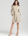 Juicy Couture puts a glam spin on the classic trench with goldtone hardware.