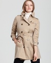 A trench so covetable, you'll find yourself wishing for rainy days--this Burberry Brit rainwear trench keeps the elements at bay and your style in check.