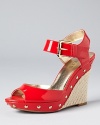 In slick and glossy coral red, GUESS's Tabari wedges boast alluring style.