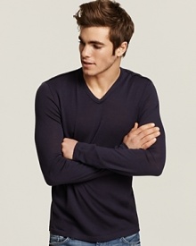 Slim fit v-neck sweater with unfinished seams for subtly rag-tag look. Slim fit v-neck sweater with unfinished seams for subtly rag-tag look.