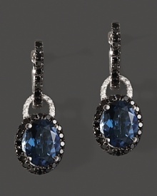 Diamonds and black diamonds circle faceted London blue topaz, set in 14K white gold. Diamonds and black diamonds circle faceted London blue topaz, set in 14K white gold.