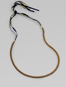 A fine herringbone chain with a gilded grosgrain ribbon tie.Brass Grosgrain ribbon Adjustable ties About 25½ long Imported A fine herringbone chain with a gilded grosgrain ribbon tie.Brass Grosgrain ribbon Adjustable ties About 25½ long Imported