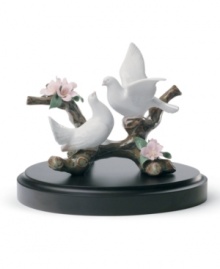Find peace in the graceful doves and pink blooms of this Lladro collectible. A serene nature scene, handcrafted in glazed porcelain. Find peace in the graceful doves and pink blooms of this Lladro collectible. A serene nature scene, handcrafted in glazed porcelain.