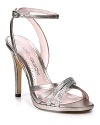 Rhinestone-strewn straps streak like sparkling comets across Caparros' elegant evening sandals.