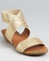 A stacked demi wedge gives a light lift to these Lucky Brand sandals, shimmering in metallic linen.