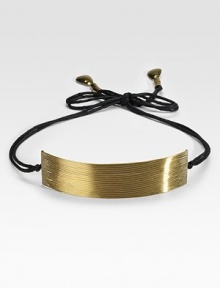 Delicate golden wires nestle together to form a curved panel that adds a warm glow to a simple dress or skirt.BrassCotton cordingTotal length, about 56 (adjustable)Brass wire panel, about 10½L X 2WTie close with hammered brass end capsImported