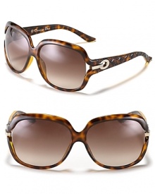 Chic oversized sunglasses with open temples and circular metal detail along arms.