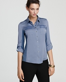 Rendered in two-tone silk, this Elie Tahari blouse infuses the classic button down with an air of femininity.