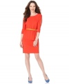 Calvin Klein takes the ordinary sheath and gives it a few stylish twists, including split three-quarter sleeves and a bright, contrasting belt. Play it up with bold-hued shoes!