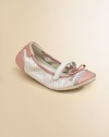 Scrunch perforated leather with patent leather trim and bow detail.Leather upper Adjustable grip-tape strap closure Rubber sole Imported