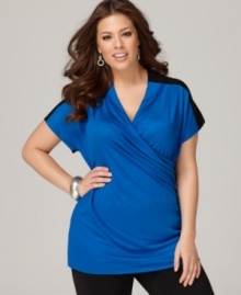 A cross front design lends a slimming shape to DKNYC's short sleeve plus size top, showcasing a colorblocked design.