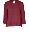 A fashionably boxier cut and a rich, autumnal hue lend this Tara Jarmon claret-hued silk top its easy elegance - Lightweight and especially flattering, thanks to a generous touch of stretch - Relaxed silhouette tapers gently through middle - Round neckline and 3/4 sleeves - Single-button closure and key hole detail at nape of neck - Fluid and feminine, seamlessly transitions from the office to evenings out - Pair with with cigarette pants, pencil skirts or leather leggings