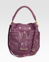 Gold hardware flawlessly complements this butter-soft leather hobo style with a bevvy of inside and outside pockets.Top handle, 6½ dropDetachable, adjustable shoulder strap, 19½ dropSnap closureThree outside open pocketsOne inside zip pocketTwo inside open pocketsFully lined12W X 14H X 2DImported