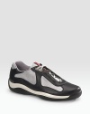 Lace-up sneaker with leather and mesh upper on a rubber sole. Padded insole Molded rubber bottom Imported 