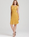 In a golden hue and delicate lace, BCBGMAXAZRIA's seamed lace dress lends a soft, feminine look.
