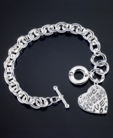 Street smart style with a beautiful twist. This GUESS bracelet is crafted in silvertone mixed metal with a stylish graffiti logo heart charm. Approximate length: 7-1/2 inches. Approximate drop: 1 inch. Street smart style with a beautiful twist. This GUESS bracelet is crafted in silvertone mixed metal with a stylish graffiti logo heart charm. Approximate length: 7-1/2 inches. Approximate drop: 1 inch.