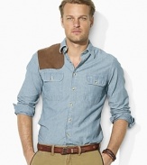 The always classic and effortlessly cool chambray workshirt becomes even more rugged with a rich indigo wash and supple suede gun patch.