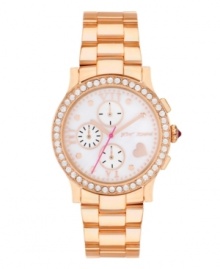 Show off your heart of rosy gold with this Betsey Johnson watch. Polished rose-gold tone stainless steel bracelet and round case. Bezel embellished with crystal accents. White mother-of-pearl chronograph dial features rose-gold tone dot markers, Roman numerals, three subdials, heart at four o'clock, rose-gold tone hour and minute hands, signature fuchsia second hand and logo. Quartz movement. Water resistant to 30 meters. Two-year limited warranty.