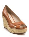 Step easily from summer to autumn in KORS Michael Kors' fawn-hued wedges. The espadrille soles echo sunny days; the rich brown leather welcomes cooler climates.