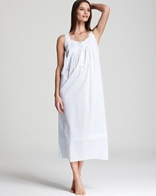 A charming long sleeveless nightgown with a pretty polka dot pattern and lace trim.