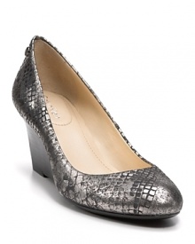 Silvery snakeskin-embossed leather slides over these stacked mini-wedges. Pair them with standard suits for alluring contrast. By Calvin Klein.