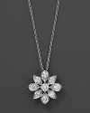 Diamonds set in a 14K. white gold flower pendant.