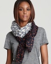 A large patchwork of various floral prints decorates this cozy wool scarf from Tory Burch.