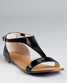 A lesson in sophistication. Boutique 9's Piraya sandals boast glossy patent leather with polished style.