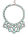 Spruce up your summer look in Monet's statement-making necklace. A rich bronze tone mixed metal setting provides the perfect backdrop for bold reconstituted turquoise stones. Approximate length: 17 inches + 2-inch extender. Approximate drop: 2-3/4 inches.