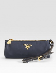 Classic roll shape with logo detail has a wristlet strap and a zipper closure. Wristlet strap, 5 drop Zipper closure Fully lined 6W X 2½H X 2½D Made in Italy Classic roll shape with logo detail has a wristlet strap and a zipper closure. Wristlet strap, 5 drop Zipper closure Fully lined 6W X 2½H X 2½D Made in Italy
