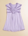 A pretty rosette and tiers of ruffles make this A-line frock absolutely fabulous.V-neckSleevelessPullover stylePurl edge hem95% rayon/5%Machine washImported