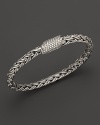 Diamonds glitter from the clasp of a sterling silver bracelet, part of the John Hardy Classic Chain Kepang collection.