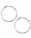 Jones New York's stylish twist on the classic hoop earring features detailed diamond-cut designs. Crafted in silver tone mixed metal. Approximate diameter: 2 inches.