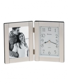 Keep time and memories close to your heart with this elegant picture frame and clock by Bulova. Hinged brushed aluminum case with picture frame at left and clock at right. Dial features black numerals, two black hands and gold tone second hand.