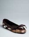 Burberry takes the prep-school good looks of a loafer into these streamlined ballet flats, tied up with a leather bow at the toe. Housecheck plaid defines this signature style.