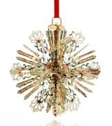 A burst of holiday brilliance, this radiant snowflake ornaments your tree with intricate spokes of gold-plated brass and flourishes of red, white and green. With 2012 hangtag.