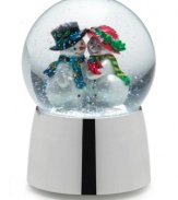 One cool couple shares a romantic moment under a flurry of snow and to the tune of Joy to the World in this adorable snow globe from Towle.
