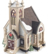 Keep the faith in a clapboard church that anchors the quaint and historical town of New Britain, part of New England Village from Department 56. A traditional wreath and light dusting of snow add to it's charm.