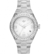 Cool down your workout with this icy mini Cambridge watch by adidas. Clear nylon plastic bracelet and round case. Silver tone bezel embellished with crystal accents. White dial features silver tone numerals at three, six and nine o'clock, stick indices, minute track, date window at four o'clock, three hands and logo at twelve o'clock. Quartz movement. Water resistant to 50 meters. Two-year limited warranty.