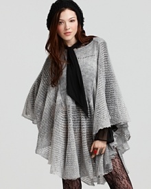 The season's must-have silhouette, this Free People cape is the perfect jacket alternative--lush in a sheer crochet knit and featuring a feminine ruffle hem. Layer over everything from boho dresses to polished trousers for winter luxe.