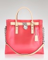 Practical style proves playful with this oversized tote from MICHAEL Michael Kors. In a bold hue and chic silhouette, this bag is clearly a trendsetting choice.