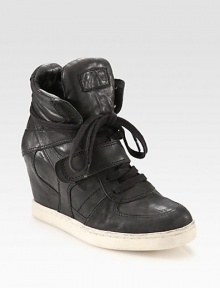 Fronted by laces and a Velcro® strap, this sporty leather sneaker has an unexpected, hidden wedge and rubber sole. Hidden wedge, 3 (75mm)Leather upperLeather liningRubber solePadded insoleImported