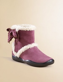 Shearling-lined boots with a suede bow.Shearling upper Rubber sole Imported Shearling-lined boots with a suede bow.Shearling upper Rubber sole Imported