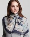 An elegant oblong silk scarf in a large floral print from Salvatore Ferragamo.