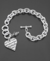 Timeless quality from one of your favorite designers. This GUESS bracelet features a logo charm scripted with Guess, Love and Joy along with a small crystal accent bead. Crafted in silvertone mixed metal with a bar and toggle closure. Approximate length: 7-1/4 inches.