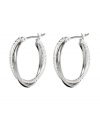 Star-worthy hoops with a hint of shimmer. Monet earrings feature a twisted hoop design in silver tone mixed metal. Approximate diameter: 7/8 inch.