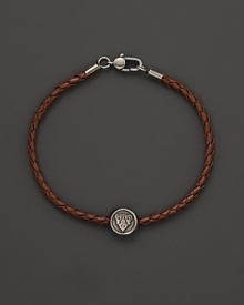 Silver Gucci charm on a braided brown natural leather bracelet. Silver Gucci charm on a braided brown natural leather bracelet.